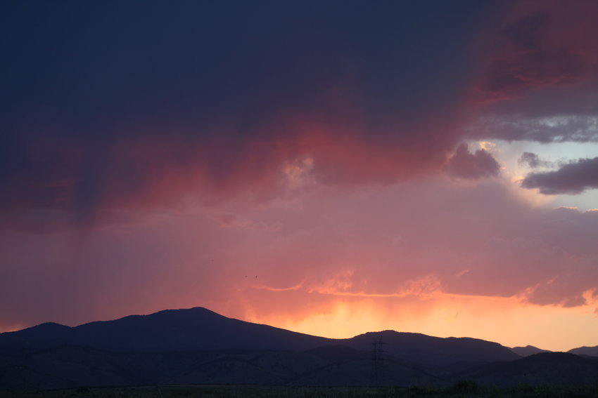 The sun sets over the foothills west of South Table Mountain on June 16.